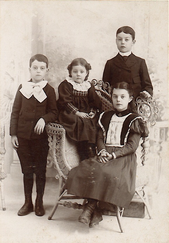 A picture of elmer Gable with baby Hattie.  Elsie is seated and Harvey, Jr. is on the right.