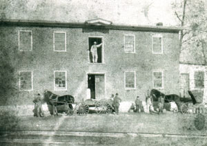 An old photo of Willoughby and millworkers at the Powder Valley Mill.